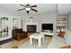 Bright living room featuring a fireplace, ceiling fan, and comfortable seating for relaxation at 10764 Northhampton Dr, Fishers, IN 46038
