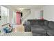 Living room showcases a gray sectional, stairs and accent decorations at 10764 Northhampton Dr, Fishers, IN 46038