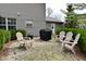 Stone patio with outdoor seating and a grill, perfect for entertaining in the backyard at 10764 Northhampton Dr, Fishers, IN 46038