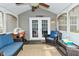 Inviting screened porch with comfortable seating, ceiling fan, and backyard views at 10764 Northhampton Dr, Fishers, IN 46038