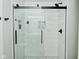 Modern shower featuring glass doors, black fixtures, and marble-style tiling at 10764 Northhampton Dr, Fishers, IN 46038