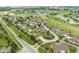 Overhead shot of a neighborhood showcasing homes with ponds, gardens, and surrounding golf course at 11438 Winding Wood Dr, Indianapolis, IN 46235