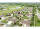 Panoramic view showcases a community near a golf course and pond, surrounded by lush greenery at 11438 Winding Wood Dr, Indianapolis, IN 46235