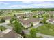 Stunning aerial view of a residential community with beautiful landscaping, a pond, and well-maintained lawns at 11438 Winding Wood Dr, Indianapolis, IN 46235