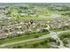 Wide aerial view of residential area with golf course, lakes, and manicured lawns at 11438 Winding Wood Dr, Indianapolis, IN 46235