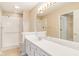 Bathroom featuring vanity with white cabinets, shower, and tile flooring at 11438 Winding Wood Dr, Indianapolis, IN 46235