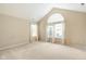 Empty bedroom with carpet and vaulted ceiling and a large window at 11438 Winding Wood Dr, Indianapolis, IN 46235