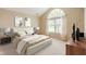 Staged bedroom with neutral colors and elegant decor at 11438 Winding Wood Dr, Indianapolis, IN 46235
