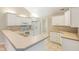 Well-lit kitchen with white cabinets, appliances, and countertops at 11438 Winding Wood Dr, Indianapolis, IN 46235