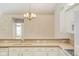 Well-equipped kitchen featuring white cabinetry, breakfast bar, and ample counter space for cooking at 11438 Winding Wood Dr, Indianapolis, IN 46235