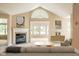 Inviting living room boasts a vaulted ceiling, fireplace, and an abundance of natural light at 11438 Winding Wood Dr, Indianapolis, IN 46235