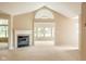 Light-filled living room with a cozy fireplace and vaulted ceilings, perfect for relaxation at 11438 Winding Wood Dr, Indianapolis, IN 46235