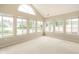 Spacious sunroom featuring vaulted ceilings and large windows overlooking the lush surroundings at 11438 Winding Wood Dr, Indianapolis, IN 46235
