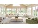 Bright and airy sunroom with multiple windows offering panoramic views and ample seating at 11438 Winding Wood Dr, Indianapolis, IN 46235