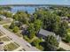 Aerial view of a suburban community near a lake, featuring mature trees and well-maintained lawns at 11536 Woods Bay Ln, Indianapolis, IN 46236