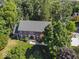 Aerial view of a two-story brick home featuring a green lawn with mature trees at 11536 Woods Bay Ln, Indianapolis, IN 46236