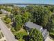 Aerial view of a suburban community near a lake, with mature trees and well-manicured lawns at 11536 Woods Bay Ln, Indianapolis, IN 46236