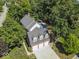 Aerial view of a two-story home featuring a brick exterior, three-car garage, and a swimming pool at 11536 Woods Bay Ln, Indianapolis, IN 46236