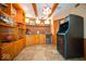 Basement bar featuring custom cabinets, brick accents, and a vintage arcade game at 11536 Woods Bay Ln, Indianapolis, IN 46236