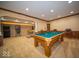 Spacious basement with a pool table, wainscotting and ample room for entertaining at 11536 Woods Bay Ln, Indianapolis, IN 46236
