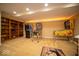 Finished basement featuring classic arcade games and built-in bookshelves at 11536 Woods Bay Ln, Indianapolis, IN 46236