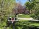 View of basketball court and green lawn at 11536 Woods Bay Ln, Indianapolis, IN 46236
