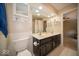 Elegant bathroom with double vanity, tiled floors, ample lighting, and a convenient toilet at 11536 Woods Bay Ln, Indianapolis, IN 46236