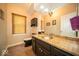 A bathroom featuring an undermount sink, granite counter and dark wood cabinets at 11536 Woods Bay Ln, Indianapolis, IN 46236