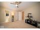 Well-lit bedroom with ceiling fan, multiple doorways, and a workspace, providing comfort and convenience at 11536 Woods Bay Ln, Indianapolis, IN 46236