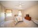 Inviting bedroom with twin bed, natural light from windows, soft carpet, and classic wooden dresser at 11536 Woods Bay Ln, Indianapolis, IN 46236