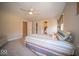 Comfortable bedroom featuring a cozy bed, soft carpet, natural light, and plenty of space to relax at 11536 Woods Bay Ln, Indianapolis, IN 46236