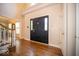 Spacious foyer boasts hardwood floors, a black front door, and access to other rooms at 11536 Woods Bay Ln, Indianapolis, IN 46236