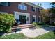 Inviting front entrance with a black door, brick steps, and landscaping at 11536 Woods Bay Ln, Indianapolis, IN 46236