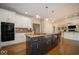 This kitchen features an island with cooktop, dual ovens, and stainless appliances at 11536 Woods Bay Ln, Indianapolis, IN 46236