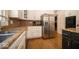 This kitchen has stainless appliances, granite counters and wood floors at 11536 Woods Bay Ln, Indianapolis, IN 46236