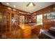 Sophisticated office with wood paneling, built-in shelving, and a large executive desk at 11536 Woods Bay Ln, Indianapolis, IN 46236