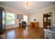 Bright office with hardwood floors, large windows, and neutral paint offers a work space at 11536 Woods Bay Ln, Indianapolis, IN 46236