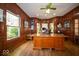 Executive office boasts wood paneling, a large desk, and bright natural light at 11536 Woods Bay Ln, Indianapolis, IN 46236