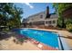Large backyard pool with diving board, fountain features, and patio area at 11536 Woods Bay Ln, Indianapolis, IN 46236
