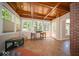 Light-filled sunroom with tile floor, wood ceiling, and access to the outdoors at 11536 Woods Bay Ln, Indianapolis, IN 46236