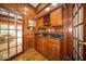 Cozy wet bar with wood cabinetry, a sink, and space to store wine and spirits at 11536 Woods Bay Ln, Indianapolis, IN 46236
