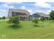 Expansive backyard with beautiful landscaping and a view of the home's exterior at 12052 Northface Dr, Noblesville, IN 46060