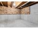Exposed basement wall showing insulation in an unfinished room at 12052 Northface Dr, Noblesville, IN 46060