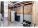 Unfinished utility area of basement with hot water tank and other utilities at 12052 Northface Dr, Noblesville, IN 46060