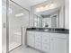 Modern bathroom boasts a double vanity, granite countertop, spacious shower, and natural light at 12052 Northface Dr, Noblesville, IN 46060