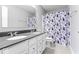 Bright bathroom featuring a double sink vanity and a floral shower curtain at 12052 Northface Dr, Noblesville, IN 46060
