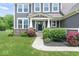 A well-manicured lawn and colorful plantings enhance the entrance to the lovely home at 12052 Northface Dr, Noblesville, IN 46060