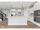 Open kitchen with island, stainless appliances, pendant lighting and view of stairs at 12052 Northface Dr, Noblesville, IN 46060
