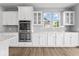 Bright kitchen features white cabinetry, stainless steel appliances and light countertops at 12052 Northface Dr, Noblesville, IN 46060