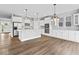 Spacious open kitchen with island, white cabinets, stainless appliances and pantry at 12052 Northface Dr, Noblesville, IN 46060
